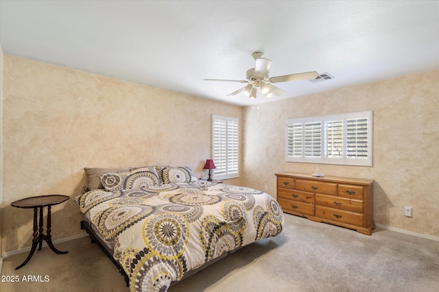 bedroom with baseboards, visible vents, carpet floors, and ceiling fan