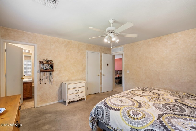 bedroom featuring connected bathroom, a ceiling fan, visible vents, and light carpet