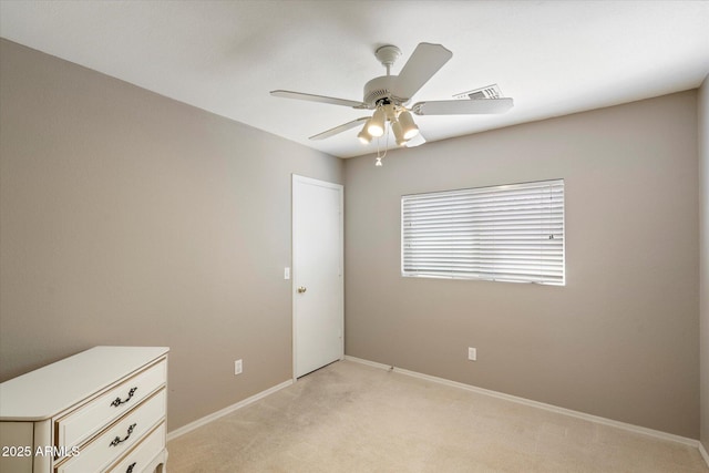 unfurnished bedroom featuring a ceiling fan, baseboards, visible vents, and light carpet