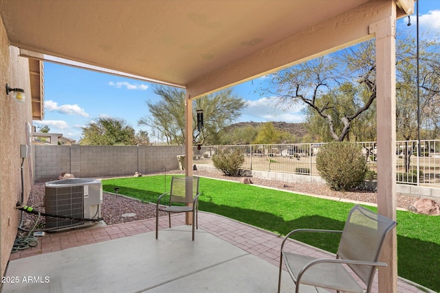 view of patio / terrace with central AC unit and a fenced backyard