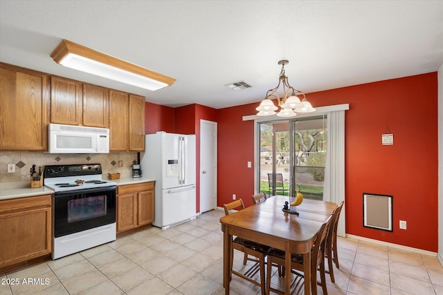 kitchen featuring white appliances, backsplash, brown cabinets, and light countertops