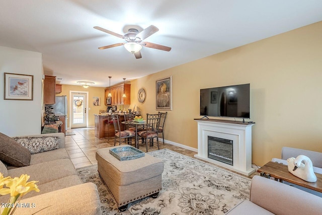 living room featuring ceiling fan and light tile patterned floors