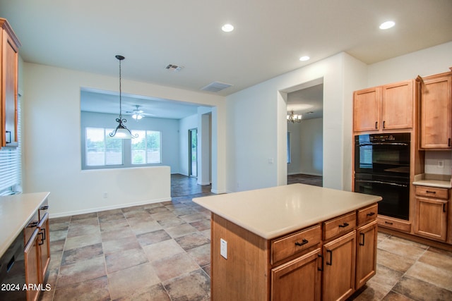 kitchen with hanging light fixtures, a center island, a chandelier, and black appliances