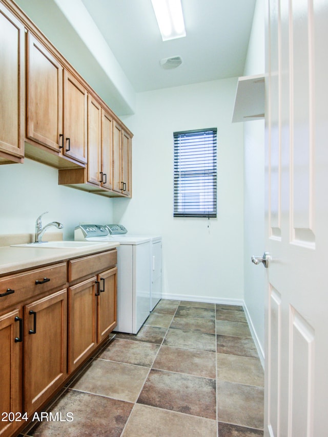 laundry area with cabinets, independent washer and dryer, and sink