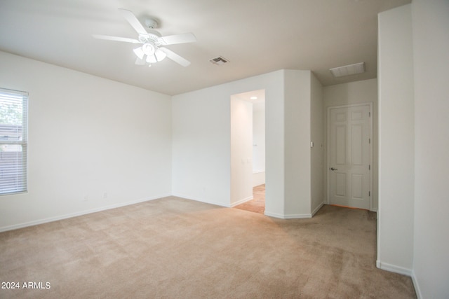 carpeted spare room with ceiling fan