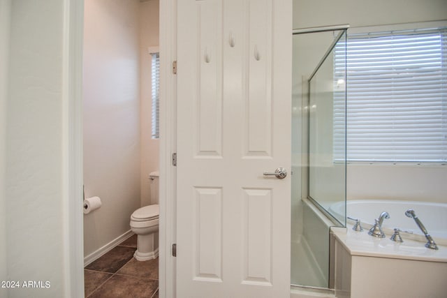 bathroom featuring tile patterned flooring, toilet, and separate shower and tub