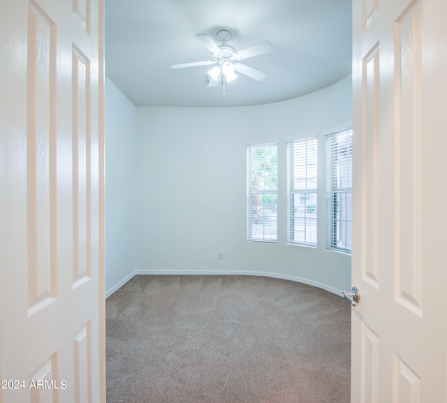 carpeted empty room with ceiling fan