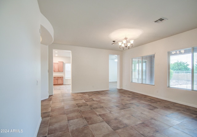 empty room featuring a chandelier