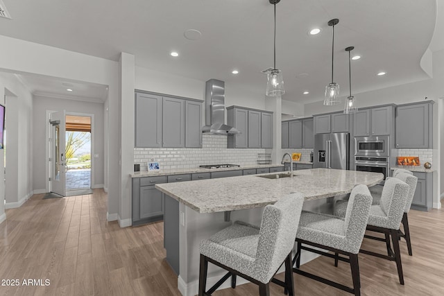 3326 Josey Wales Way, Wickenburg, AZ 85390 - kitchen featuring stainless steel appliances, wall chimney exhaust hood, gray cabinets, a sink, and baseboards