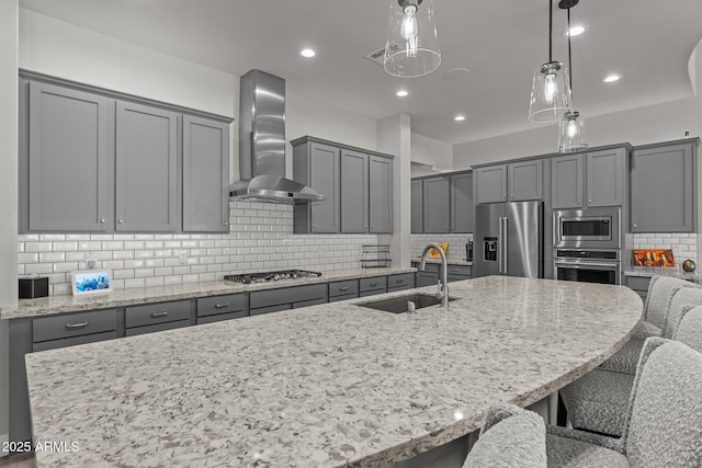 3326 Josey Wales Way, Wickenburg, AZ 85390 - kitchen with appliances with stainless steel finishes, wall chimney range hood, a sink, gray cabinets, and decorative backsplash
