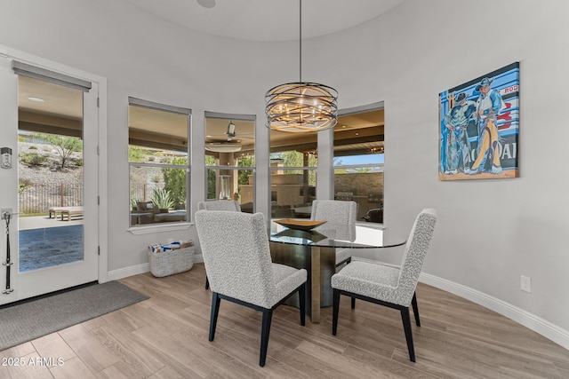 3326 Josey Wales Way, Wickenburg, AZ 85390 - dining space featuring a chandelier, wood finished floors, baseboards, and healthy amount of natural light