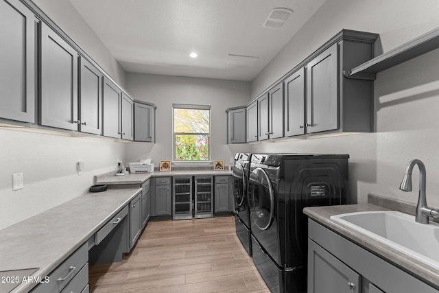3326 Josey Wales Way, Wickenburg, AZ 85390 - laundry area with washing machine and dryer, cabinet space, light wood-type flooring, wine cooler, and recessed lighting