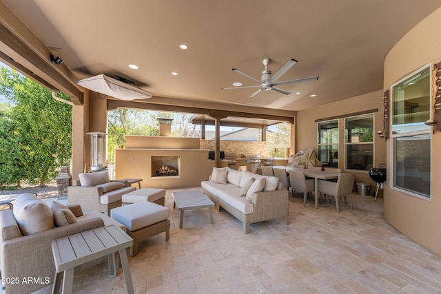 3326 Josey Wales Way, Wickenburg, AZ 85390 - view of patio / terrace with an outdoor living space with a fireplace, ceiling fan, exterior kitchen, and grilling area