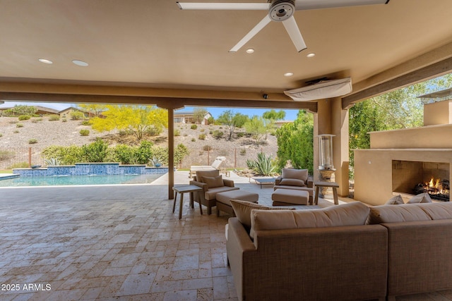 3326 Josey Wales Way, Wickenburg, AZ 85390 - view of patio / terrace with an outdoor living space with a fireplace, ceiling fan, and an outdoor pool