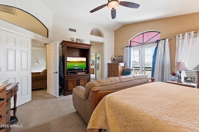 carpeted bedroom with vaulted ceiling, ceiling fan, and french doors