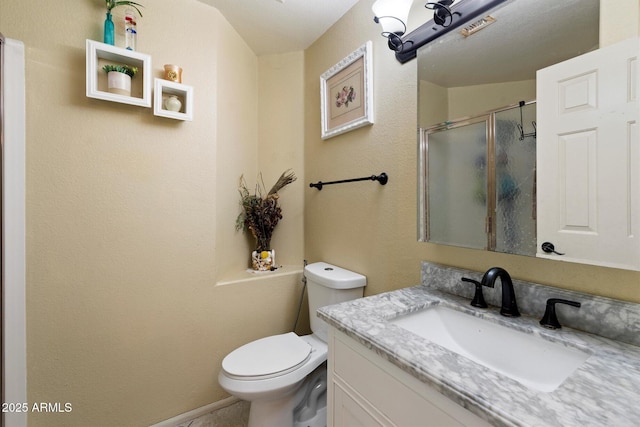 bathroom featuring vanity, toilet, and walk in shower