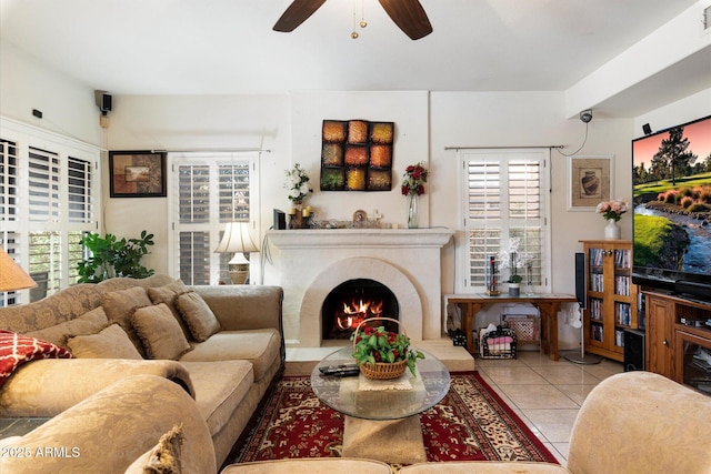 living room featuring light tile patterned floors and ceiling fan