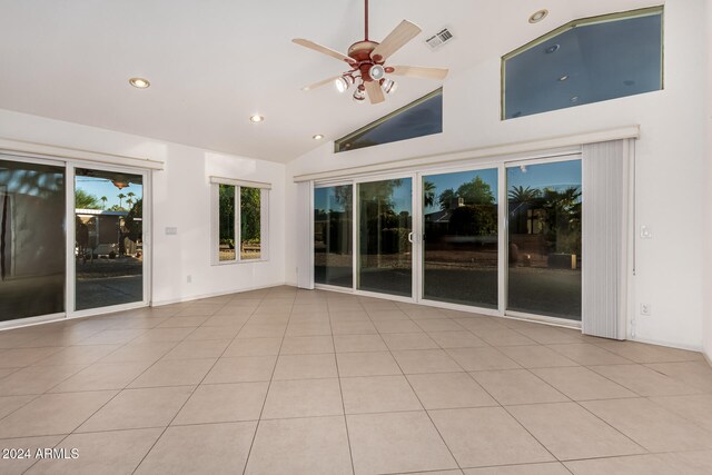 unfurnished room with ceiling fan, high vaulted ceiling, and light tile patterned floors