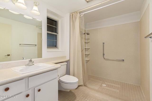 bathroom with vanity, tile patterned flooring, toilet, and walk in shower