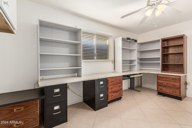 tiled office space with built in desk and ceiling fan