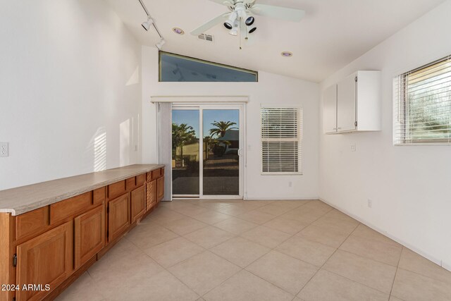 interior space featuring vaulted ceiling, ceiling fan, and plenty of natural light