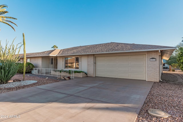 ranch-style house featuring a porch and a garage