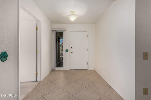 corridor featuring light tile patterned floors