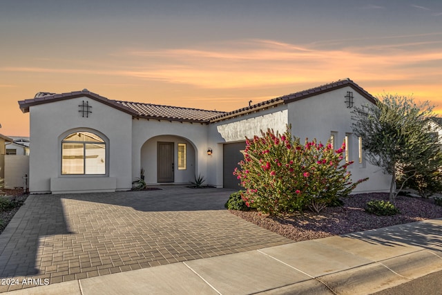 mediterranean / spanish home featuring a garage