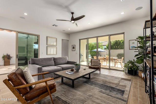 living room featuring light wood-type flooring and ceiling fan