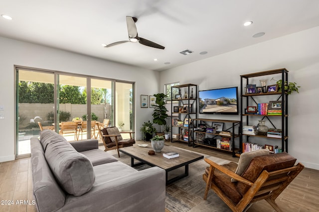 living room featuring wood-type flooring and ceiling fan