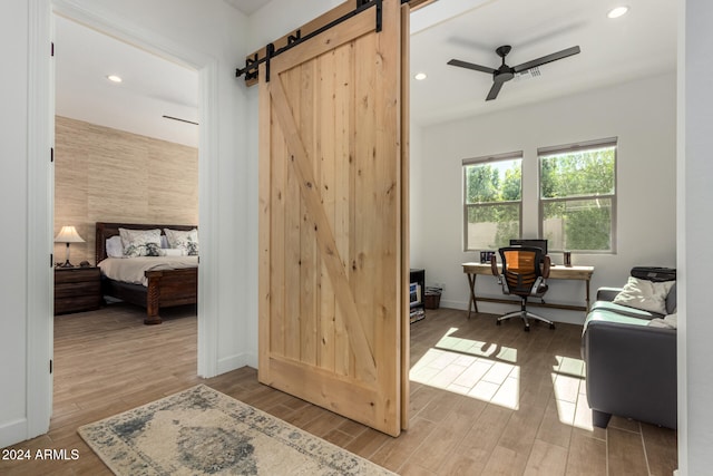 interior space featuring a barn door and hardwood / wood-style flooring