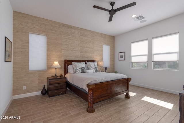 bedroom with light hardwood / wood-style floors and ceiling fan