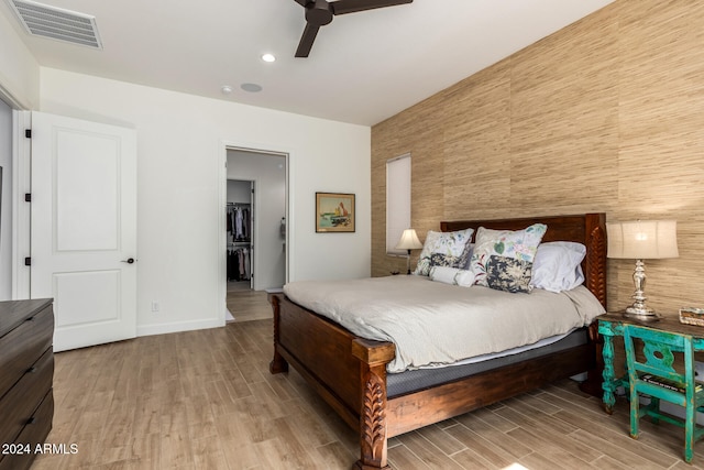 bedroom with ceiling fan and light hardwood / wood-style floors