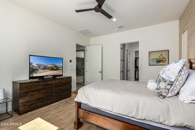 bedroom with ceiling fan and light wood-type flooring