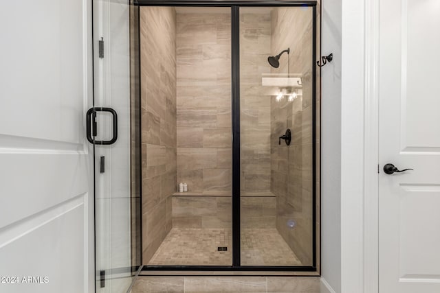 bathroom featuring a shower with shower door