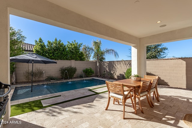 view of pool with pool water feature and a patio area