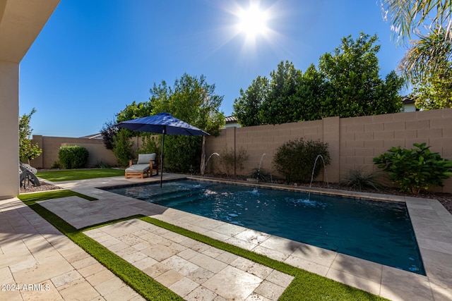 view of swimming pool featuring pool water feature and a patio