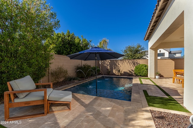 view of pool with pool water feature and a patio