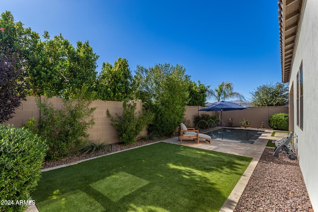 view of yard featuring a patio and a fenced in pool