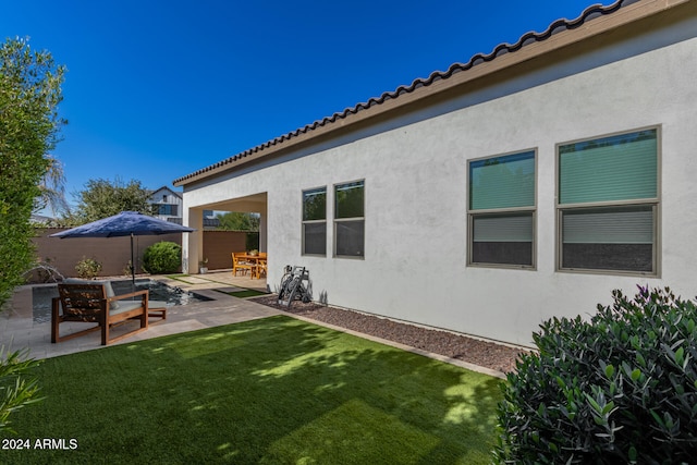 exterior space featuring a patio area and a lawn