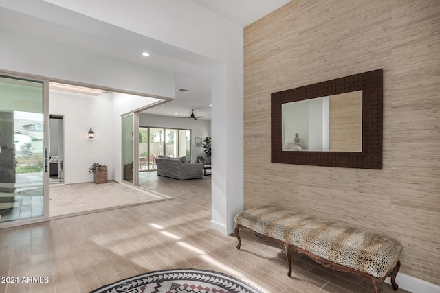 corridor featuring hardwood / wood-style floors and tile walls