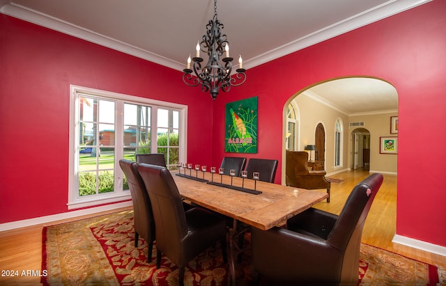 dining area featuring an inviting chandelier, crown molding, and hardwood / wood-style floors