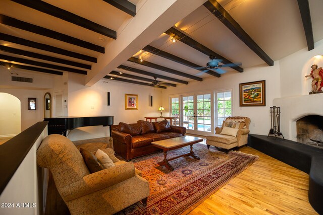 living room featuring beam ceiling, french doors, light wood-type flooring, and ceiling fan