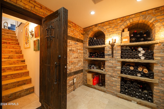 wine room featuring brick wall