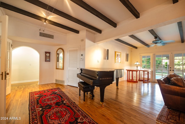 miscellaneous room with beamed ceiling, french doors, light wood-type flooring, and ceiling fan