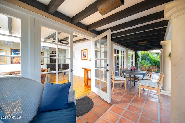 interior space featuring beam ceiling and ceiling fan