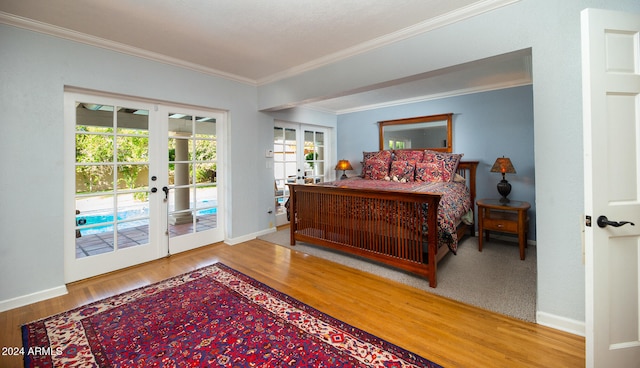 bedroom with french doors, ornamental molding, access to exterior, and wood-type flooring