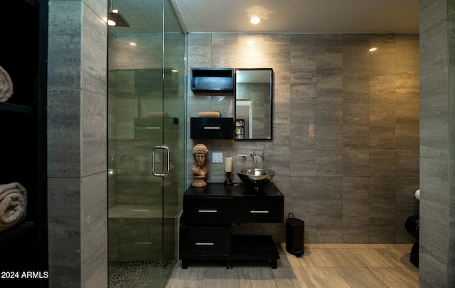 bathroom with vanity, tile walls, tile patterned flooring, and walk in shower