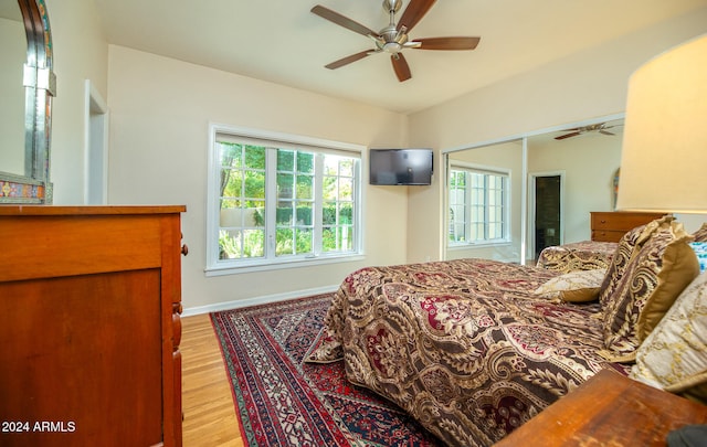 bedroom featuring light hardwood / wood-style flooring, a closet, and ceiling fan