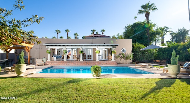 view of pool featuring a patio, a pergola, a lawn, and a diving board